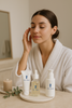 A woman enjoying a serene skincare ritual with Lab Lustre products.